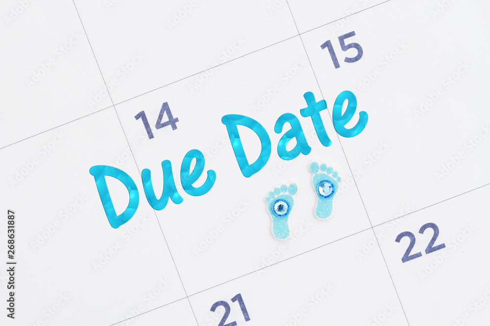 Due Date message on a monthly calendar with tiny baby footprints Due Date message on a monthly calendar with tiny baby footprints