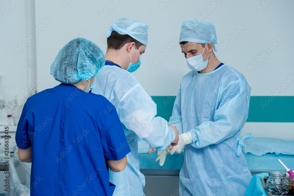 Spinal surgery. Group of surgeons in operating room with surgery equipment. Laminectomy Spinal surgery. Group of surgeons in operating room with surgery equipment. Laminectomy