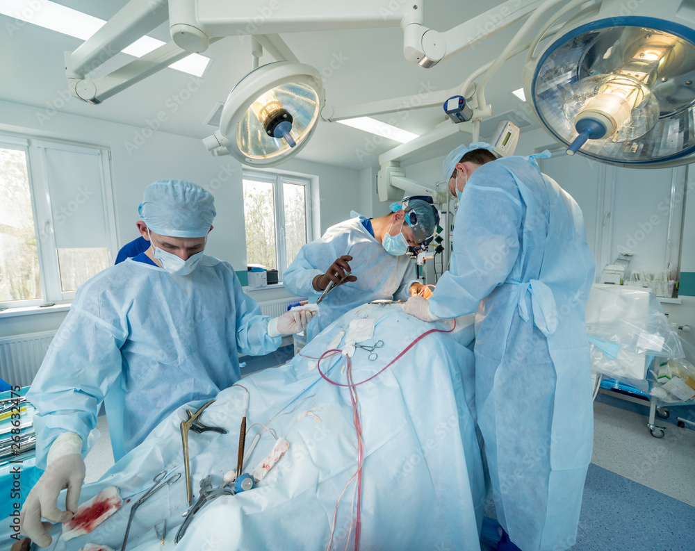 Spinal surgery. Group of surgeons in operating room with surgery equipment. Laminectomy Spinal surgery. Group of surgeons in operating room with surgery equipment. Laminectomy