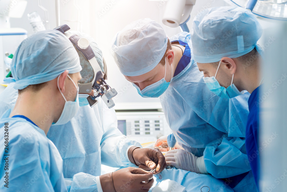 Spinal surgery. Group of surgeons in operating room with surgery equipment. Laminectomy Spinal surgery. Group of surgeons in operating room with surgery equipment. Laminectomy