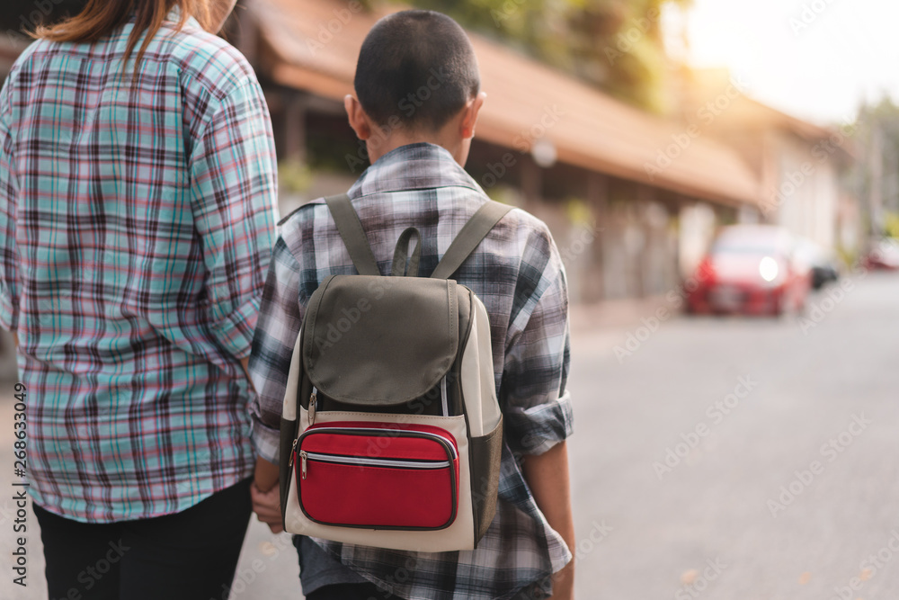 Mother or parent holding hand son or pupil with backpack go to school, Back to school concept, Selective focus. Mother or parent holding hand son or pupil with backpack go to school, Back to school concept, Selective focus.