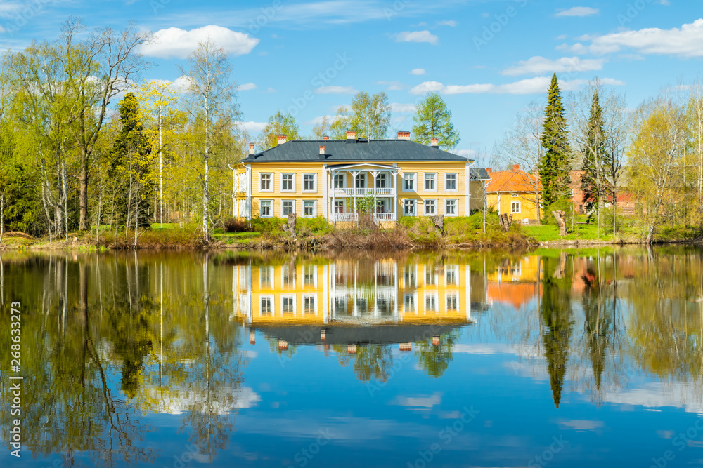 Kouvola, Finland - May 16, 2019: Beautiful wooden Rabbelugn Manor - Takamaan Kartano. Wrede family house was built in 1820 on the river Kymijoki bank. Kouvola, Finland - May 16, 2019: Beautiful wooden Rabbelugn Manor - Takamaan Kartano. Wrede family house was built in 1820 on the river Kymijoki bank.