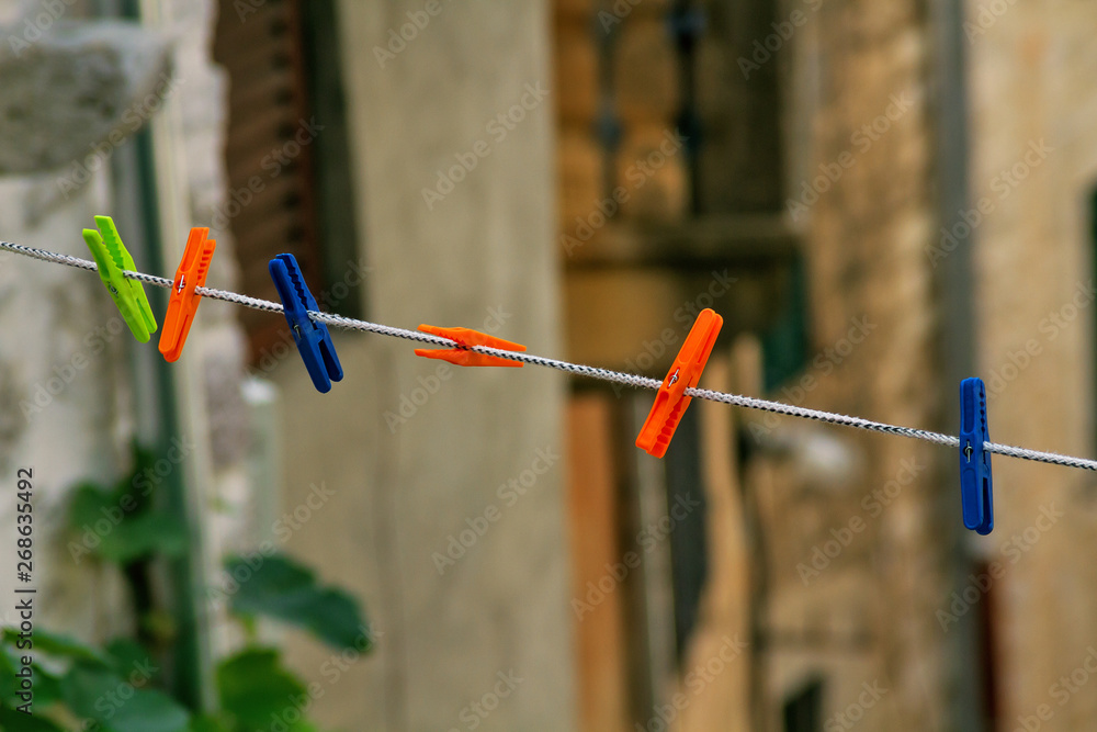 colorful clothespins on a rope on a blurred background colorful clothespins on a rope on a blurred background