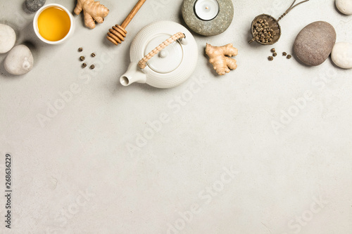 Asian tea set and spa stones on concrete background