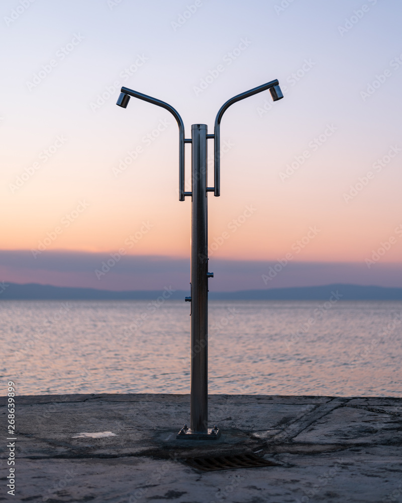 A shower at the beach of Cres after sunset