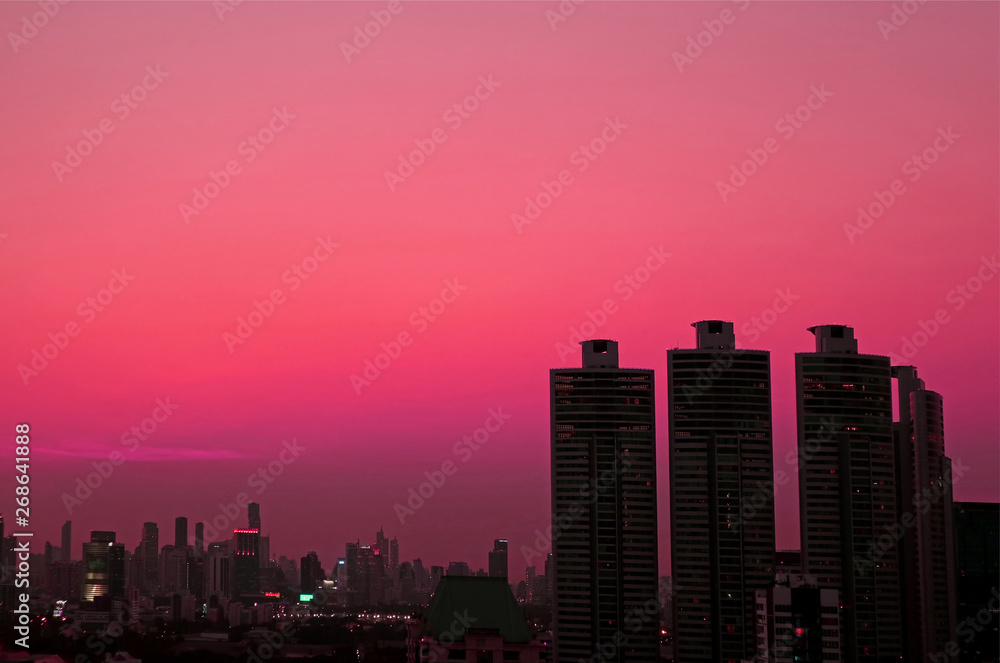 Silhouette of skyscrapers Against Evening Sky in Vibrant Pink Gradation 