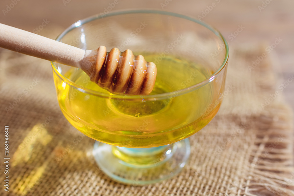 Honey with honey dipper on wooden table Honey with honey dipper on wooden table