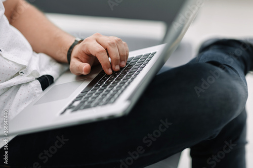 Fototapeta Naklejka Na Ścianę i Meble -  close up. businessman using laptop sitting on sofa