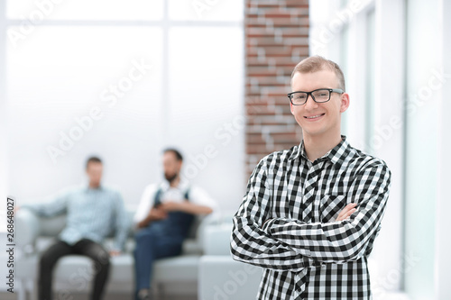 Wallpaper Mural serious young man standing in spacious office Torontodigital.ca