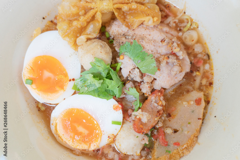 Noodle tom yum with pork and egg . Noodle tom yum with pork and egg .