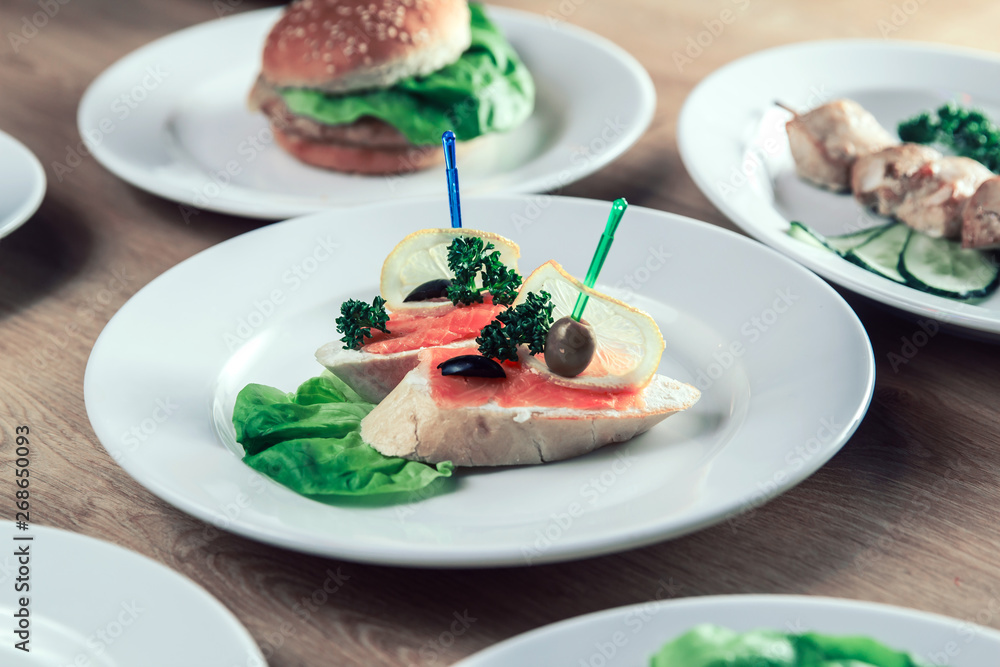 appetizer with salted salmon and other dishes on the table. appetizer with salted salmon and other dishes on the table.
