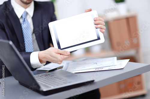 close up.businessman showing tablet with blank screen