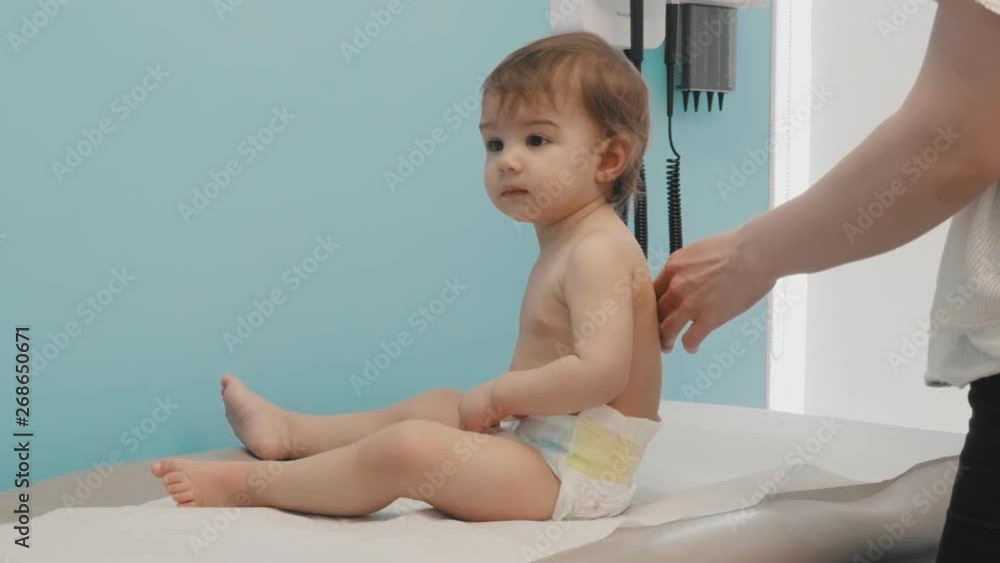 Baby girl waiting to get her vaccination shots. 4K footage. Baby girl waiting to get her vaccination shots. 4K footage.