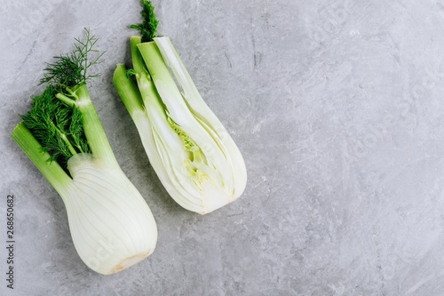 Fresh raw organic florence fennel bulbs or fennel bulb on gray stone background.