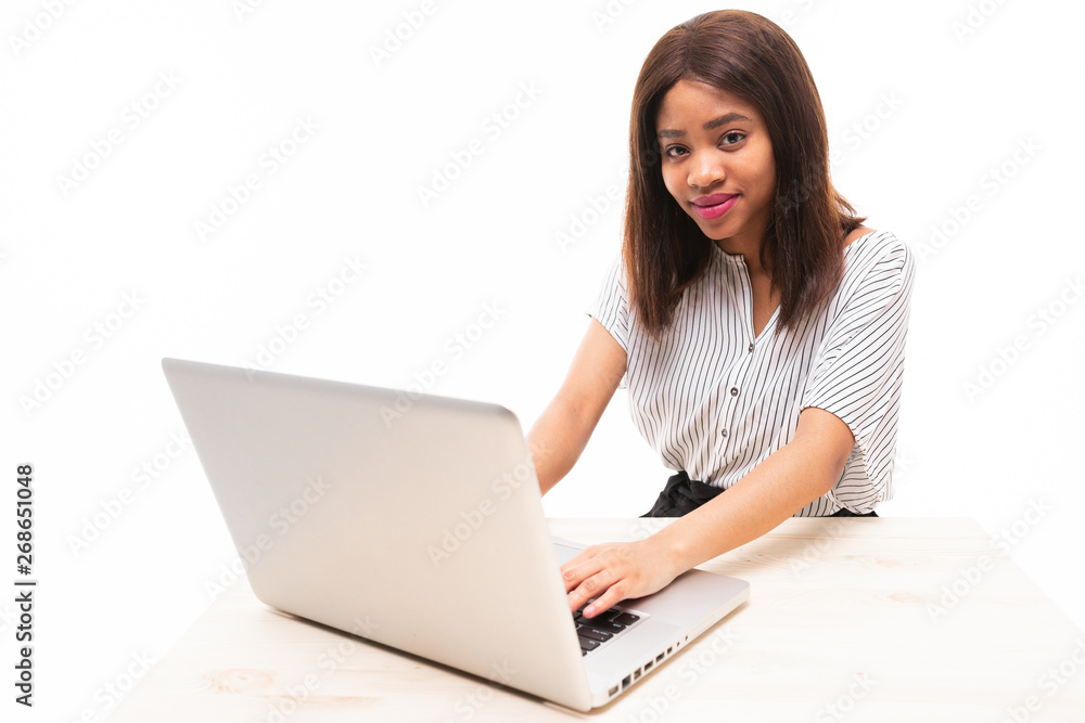 dark-skinned young girl typing on the laptop isolated on background dark-skinned young girl typing on the laptop isolated on background