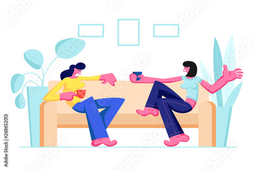 Couple of Girl Friends Sitting on Couch, Drinking Beverages and Communicating at Home