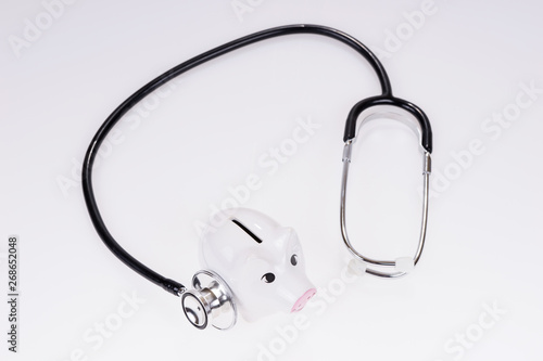 Stethoscope and piggy bank isolated. Medical or financial concept