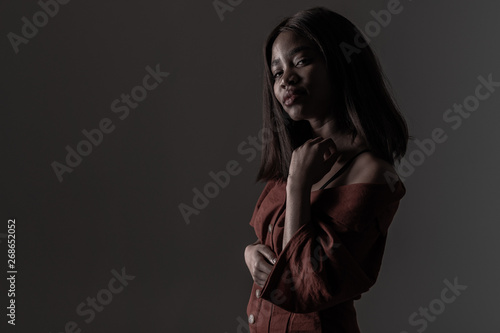 Portrait of a beautiful natural young African woman possing over black background © Ivan Traimak