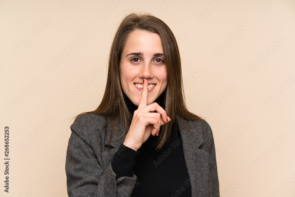 Young woman over isolated wall doing silence gesture Young woman over isolated wall doing silence gesture