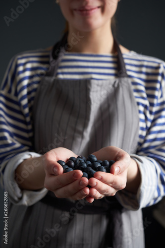 Woman's hands full of blueberries