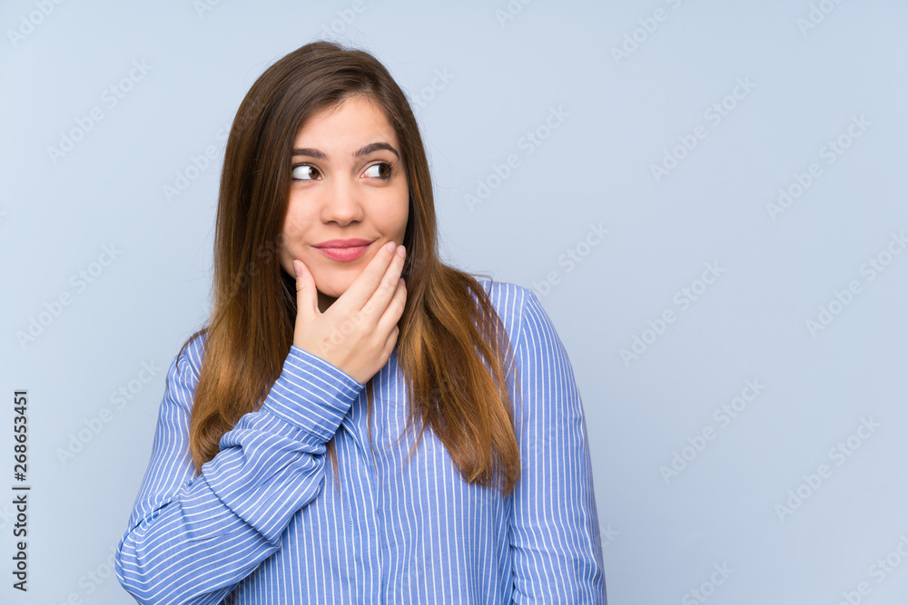 Young girl with striped shirt thinking an idea Young girl with striped shirt thinking an idea