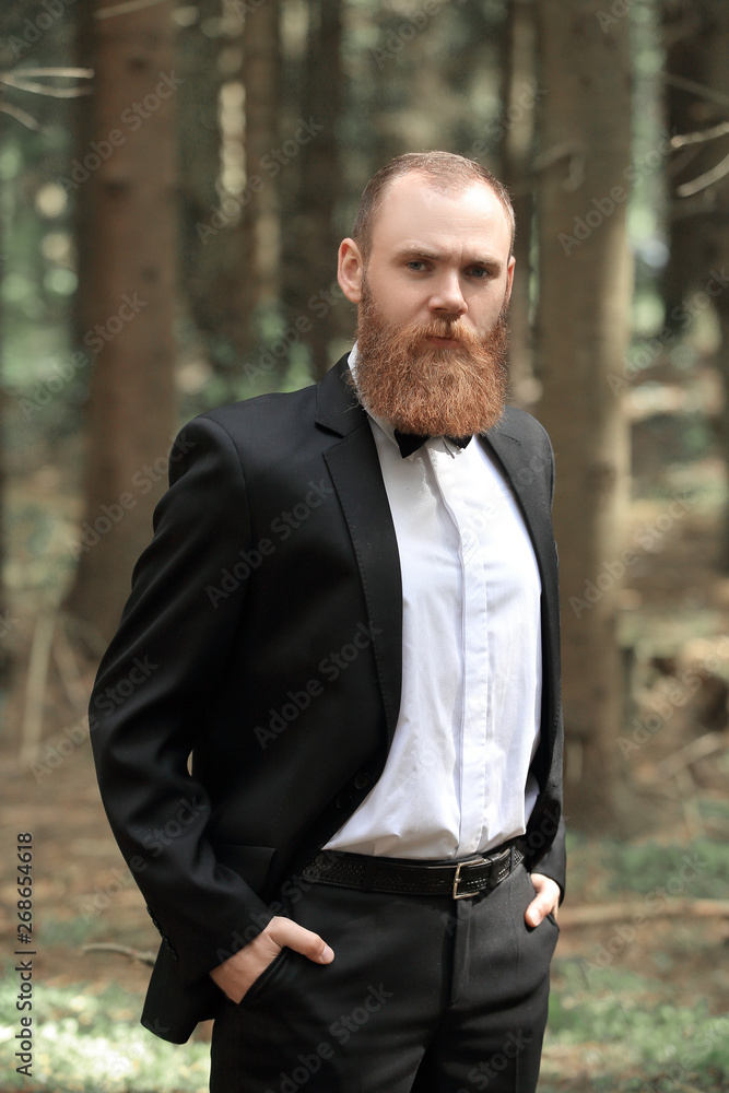 portrait of a successful businessman on a walk in the woods portrait of a successful businessman on a walk in the woods