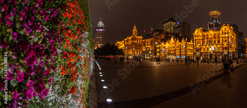 Blurred view Shanghai Pudong Development Bank. Night background. A wall of flowers on the embankment in Shanghai, China. Chenyi Square photo
