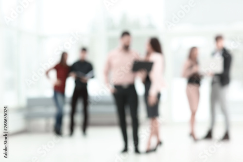 blurred image of a group of business people talking in the office lobby. business background