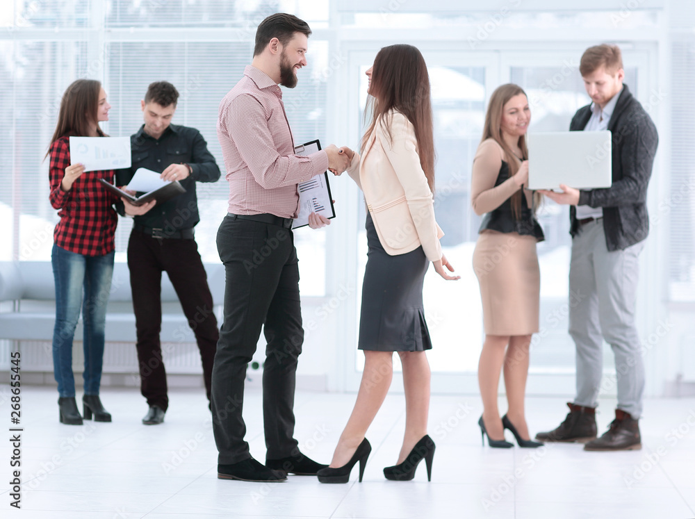 Fototapeta premium Business partners shaking hands in meeting hall
