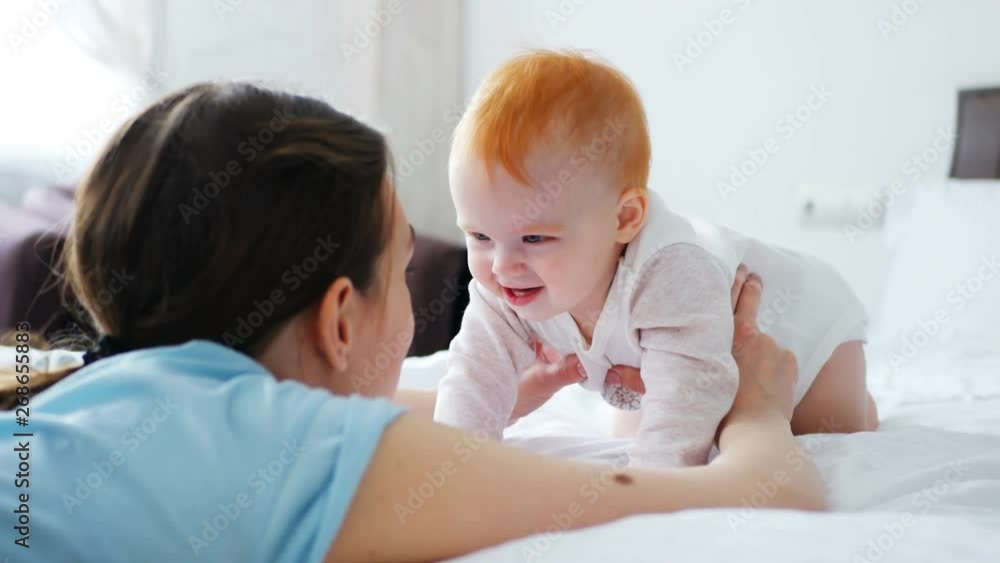 Mother and Baby. Happy Family. Mom With her readhead daughter smiling and laughing at home. Mother and Baby. Happy Family. Mom With her readhead daughter smiling and laughing at home.