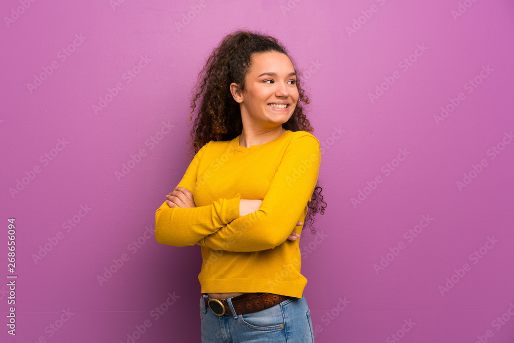 Teenager girl over purple wall with arms crossed and happy Teenager girl over purple wall with arms crossed and happy