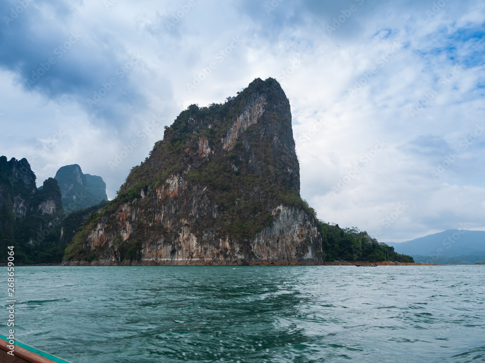 Scenic landscape of boat view in the big river and reservoir dam with mountain and nature forest Scenic landscape of boat view in the big river and reservoir dam with mountain and nature forest