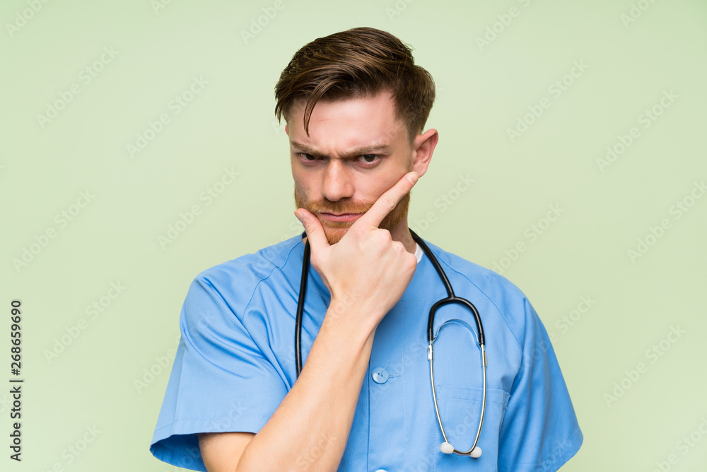 Surgeon doctor man standing and thinking an idea Surgeon doctor man standing and thinking an idea
