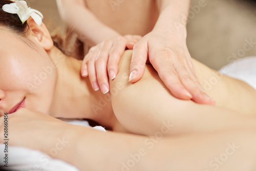 Beautician massaging woman