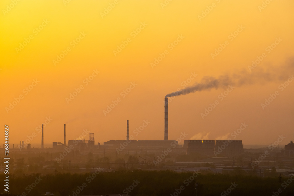 sunset over industrial areas with factories