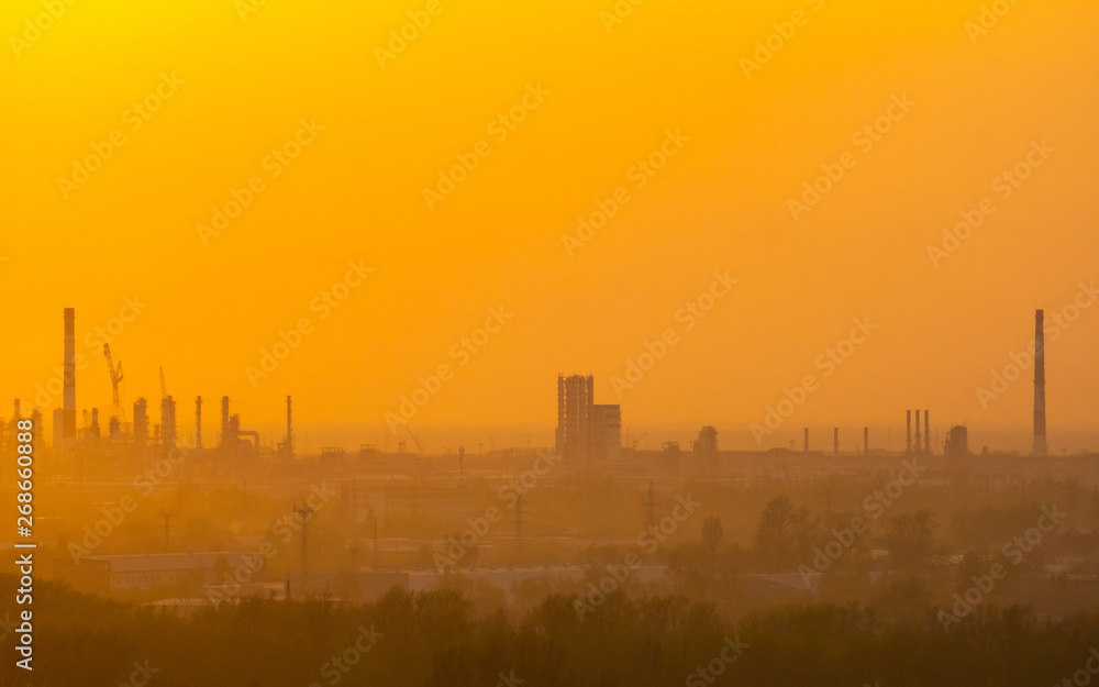 sunset over industrial areas with factories