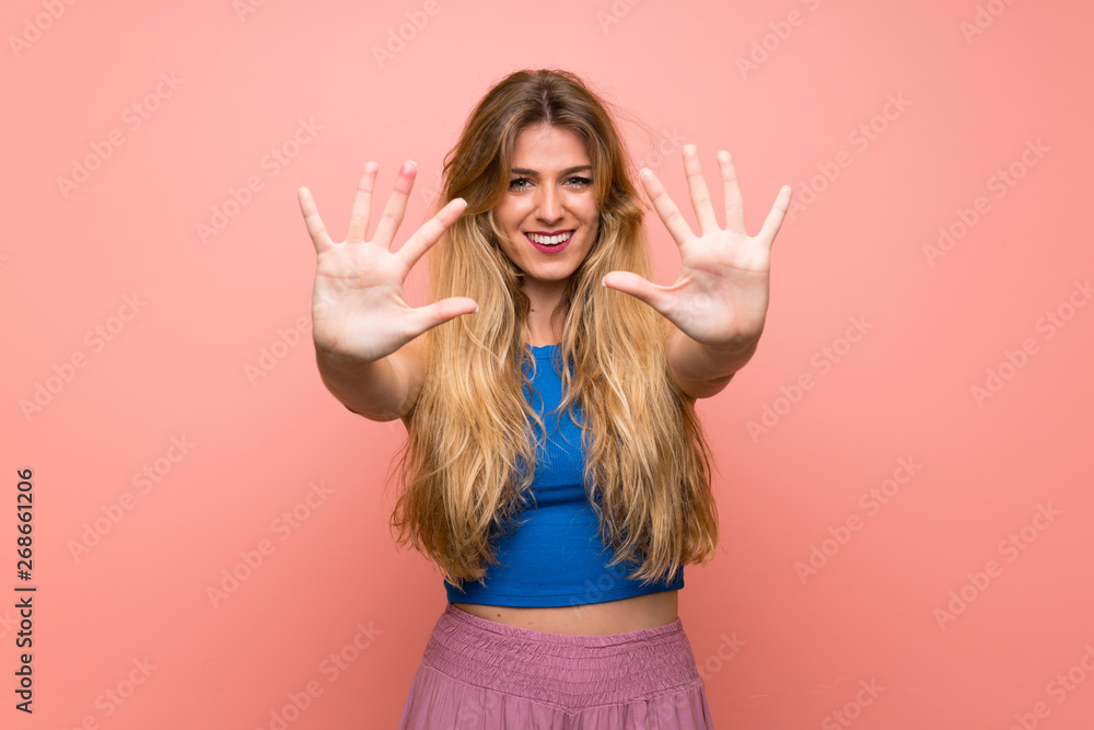 Young blonde woman over isolated pink background counting ten with fingers Young blonde woman over isolated pink background counting ten with fingers