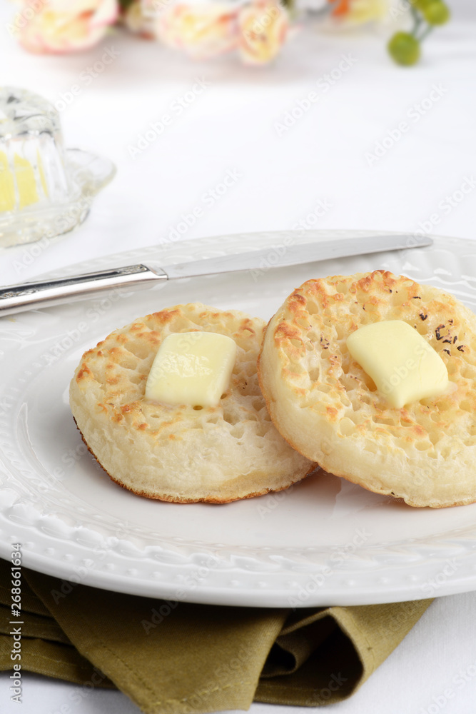 english crumpets with melting butter and a knife english crumpets with melting butter and a knife
