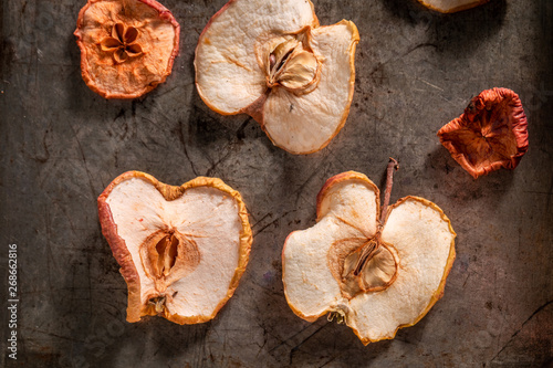 Top view of sweet dried apples on old baking tray