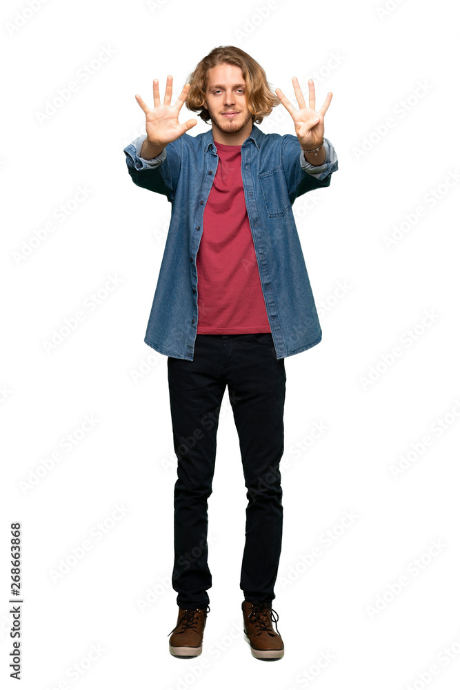 Full-length shot of Blonde man counting nine with fingers over isolated white background Full-length shot of Blonde man counting nine with fingers over isolated white background