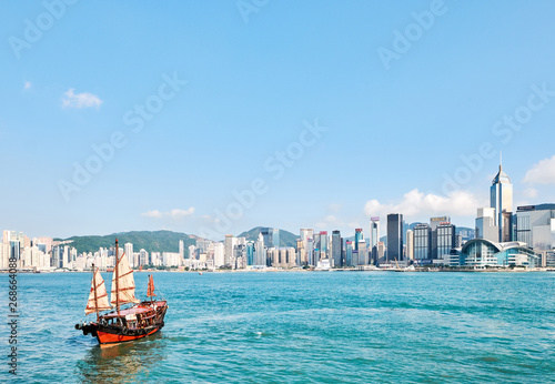 Red boat sailing in Victoria Harbour, Hong Kong, China