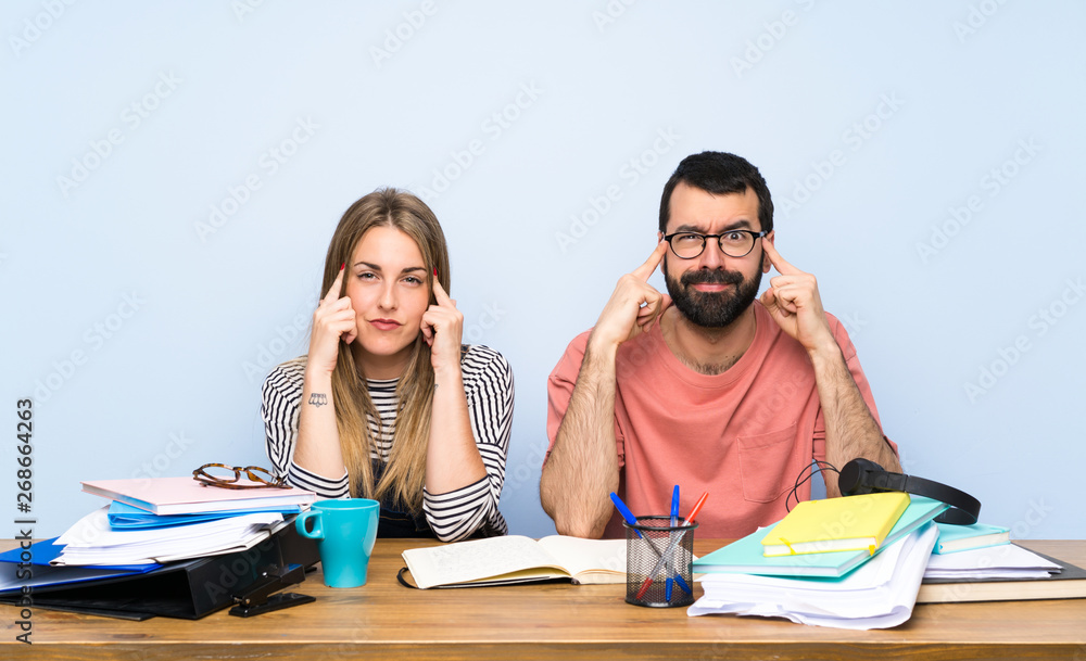 Students with many books having doubts and thinking Students with many books having doubts and thinking