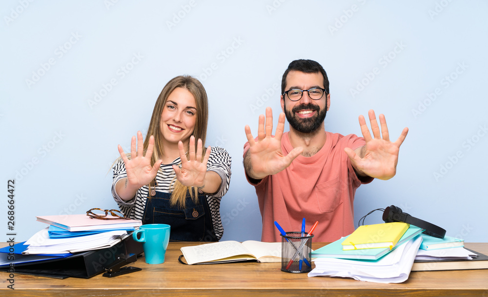 Students with many books counting ten with fingers Students with many books counting ten with fingers
