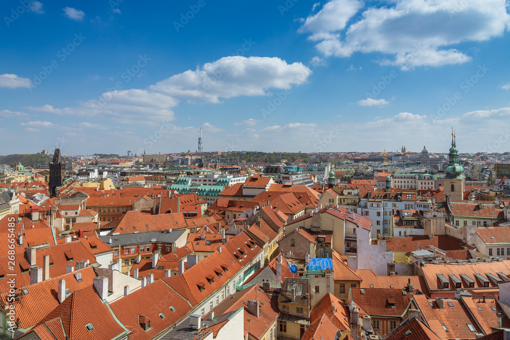 Aerial panoramic top view above old town and city skyline with famous attraction; The Powder and Henry's Tower and Television Tower against blue sky on sunny day in summer in Prague, Czech Republic.