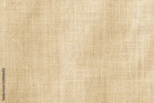 Hessian sackcloth woven texture pattern background in yellow beige cream brown color