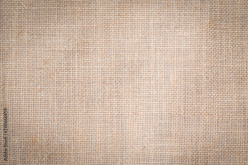 Hessian sackcloth woven texture pattern background in tan sepia beige cream brown color
