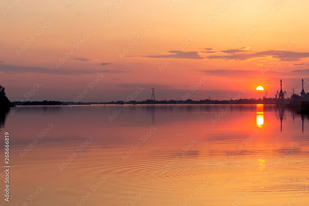 Beautiful orange sunset on the river.