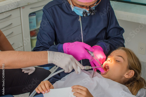 Child girl in specialized dental treatment as routine