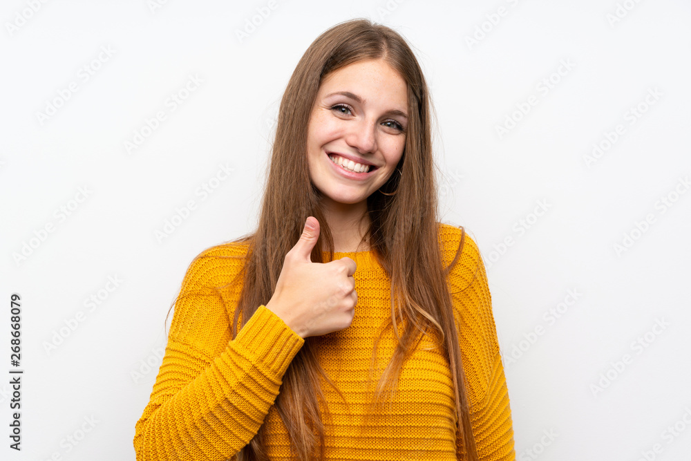 Young woman with yellow over isolated white wall giving a thumbs up gesture Young woman with yellow over isolated white wall giving a thumbs up gesture