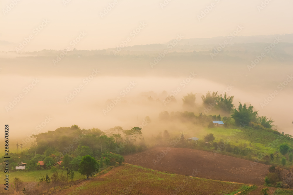 Fototapeta premium Beautiful sunrise over mountain village with fog, Spring Landscape.